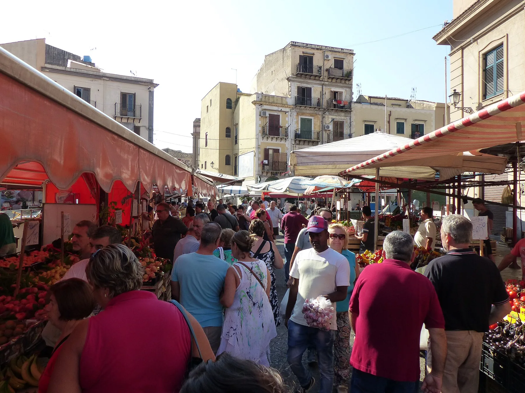 Shoppers between the stalls of Ballarò market in Palermo